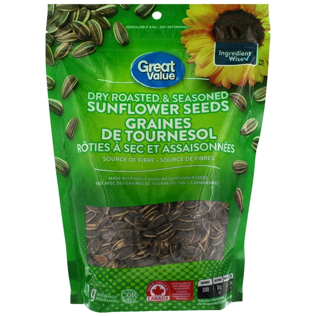 Great Value Dry Roasted & Seasoned Sunflower Seeds in a green resealable bag with bilingual English-French text and a sunflower image, containing dry roasted in-shell sunflower seeds made from 100% Canadian ingredients, a fibre-rich snack ideal for picnics or road trips.
