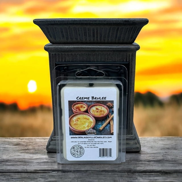 Crème Brulee Vegan Soy Wax, Hand-poured, Eco-friendly Bakery, Food, Drink Wax Melt 4 Pack by Walkerville Candles. The packaging features an image of crème brulee desserts with cinnamon sticks, set against a rustic background. The wax melts are made from 100% natural soy wax, vegan-friendly, cruelty-free, and phthalate-free, offering a rich aroma of vanilla custard and buttery caramel. Displayed in front of a decorative wax warmer with a sunset in the background.