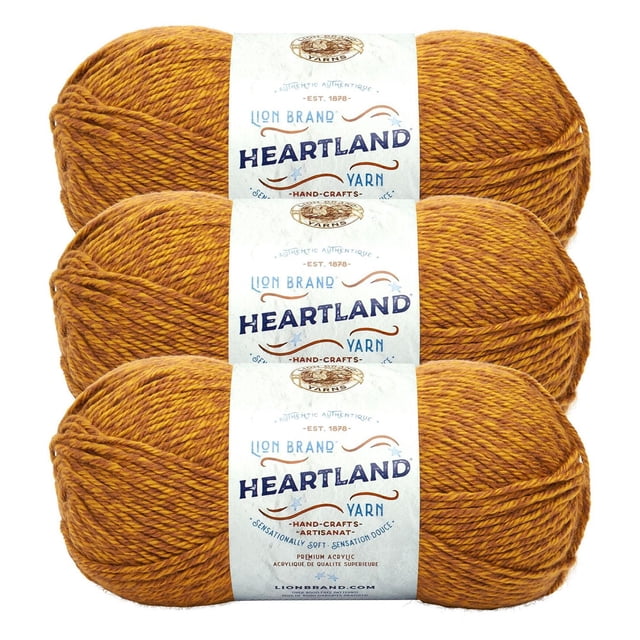 Lion Brand Yarn Heartland Yarn 3Pack featuring three skeins of worsted weight acrylic yarn in a heathered golden brown shade, each with a white label displaying brand and product information, machine washable and ideal for knitting, crochet, and durable handmade crafts.