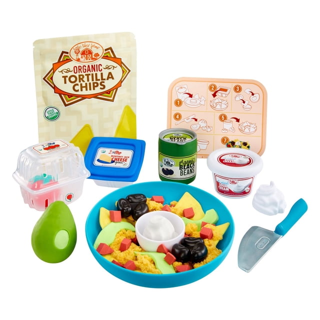 Little Tikes Creative Chefs™ Nacho Kit with a blue bowl of moldable Make-It! Mix™ nachos, green avocado slices, black beans, and red cheese cubes, plus play food containers for organic tortilla chips, Monterey Jack cheese, black beans, sour cream, a blue-handled chef’s knife, and a visual recipe card for realistic kitchen play.