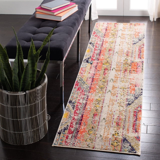 Safavieh Madison Christabella Overdyed Striped Area Rug runner featuring a multicolored distressed stripe pattern in red, orange, yellow, blue, and beige tones on dark hardwood flooring beside a black tufted bench with chrome legs and a woven basket planter with snake plants, ideal for adding durable style to transitional home interiors.