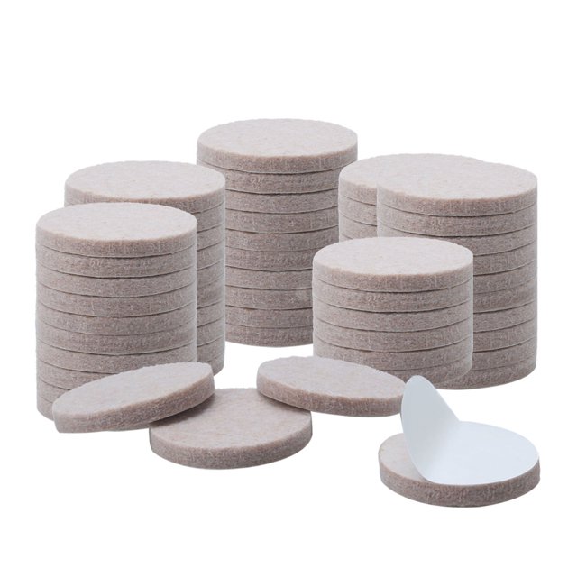 Unique Bargains Felt Furniture Pad Round 1' Self Adhesive Anti-scratch Anti-slip Protector, shown in a set of 60 pieces. The pads are round, beige in color, and feature a self-adhesive backing for easy installation. Designed to protect floors from scratches and reduce noise, they are suitable for use on furniture legs, cabinets, and other surfaces. The image displays multiple stacks of the felt pads, with one pad flipped to reveal the adhesive side.