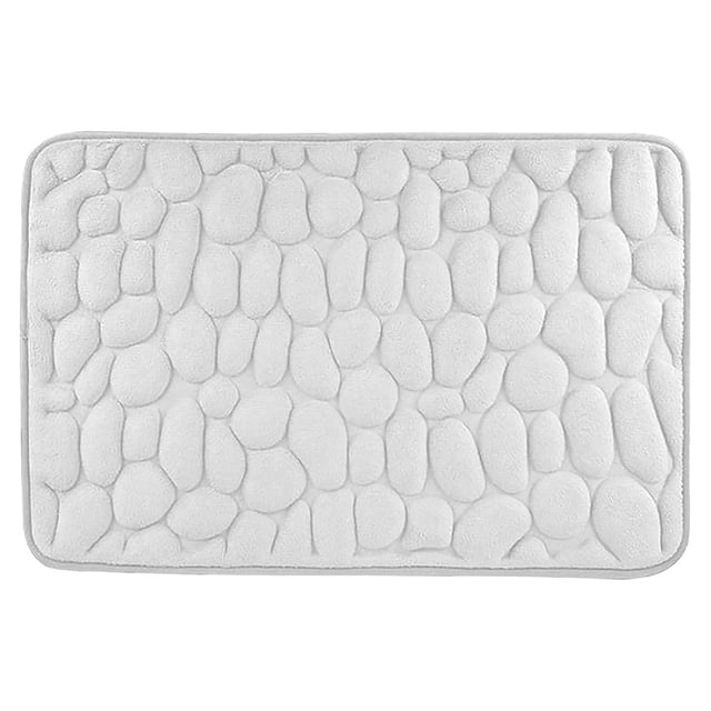 Zanvin absorbent soft memory foam mat designed for bathroom, bedroom, or shower use. The rectangular mat features a textured, embossed stone-like pattern on its soft polyester surface, offering a low pile height for comfort. It includes a non-slip polyvinyl chloride backing for safety and is water absorbent and machine washable. Suitable for various spaces such as entryways, kitchens, and living rooms, this versatile mat measures 80x50 cm and is ideal for home decor or as a thoughtful gift.