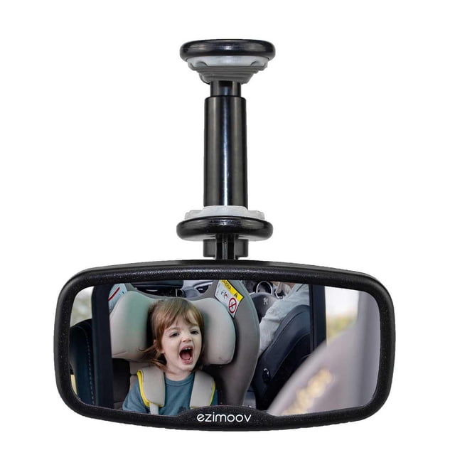 Ezi Mirror Clip - Fully Adjustable Rear Seat Mirror made from 80% recycled plastic, clipped onto a car's rearview mirror. The black-framed acrylic mirror shows a child secured in a rear-facing car seat, enabling safe monitoring of rear passengers. The clip-on design fits most vehicle mirrors and adjusts for optimal viewing angles.