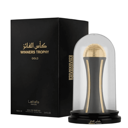 Lattafa Pride Winners Trophy Gold Eau De Parfum Spray 3.4 oz, a luxury fragrance with a gold and black trophy-shaped bottle encased in a clear dome, displayed alongside its sophisticated black packaging with gold accents.