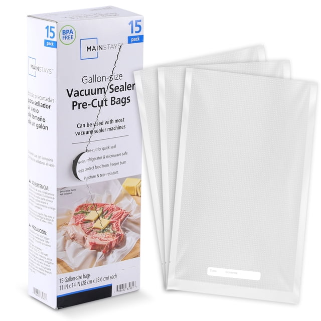 Mainstays Pre-Cut Vacuum Seal Bags, 1 Gallon, 15 Count, clear embossed plastic bags next to a box showing a vacuum-sealed steak, designed for vacuum sealing systems to remove air, prevent freezer burn, and safe for freezer, refrigerator, microwave, and sous vide cooking.