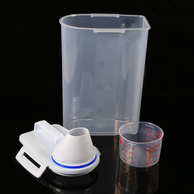 Pet Food Storage Container set including a transparent plastic container with a secure white lid featuring a spout and handle, and a measuring cup with red markings. The container measures approximately 15 x 28.8 x 9 cm and is designed for storing dry pet food. The lid has a unique buckle design for leakproof and moistureproof sealing, and the spout allows for easy pouring without removing the lid. The measuring cup doubles as a cover for the spout.