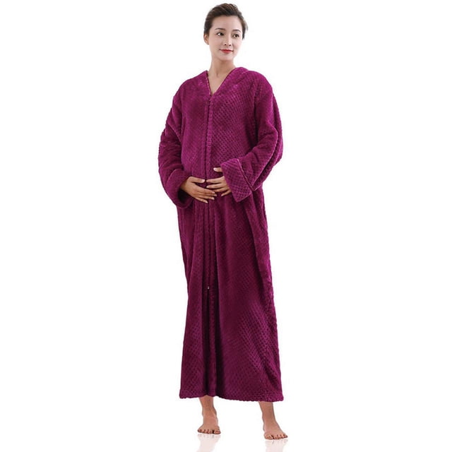 Women's Flannel Robe Zipper Front Long Plush Full Length Bathrobe with Pockets M-XL by Artfasion. The robe is made of 100% polyester with a soft, plush texture and features a full-length design in a solid magenta color. It has a zipper closure, long sleeves, an oblique V-neck, and two large pockets. Suitable for lounging, staying warm, or as a maternity robe. The model is shown wearing the robe barefoot in a neutral studio setting.