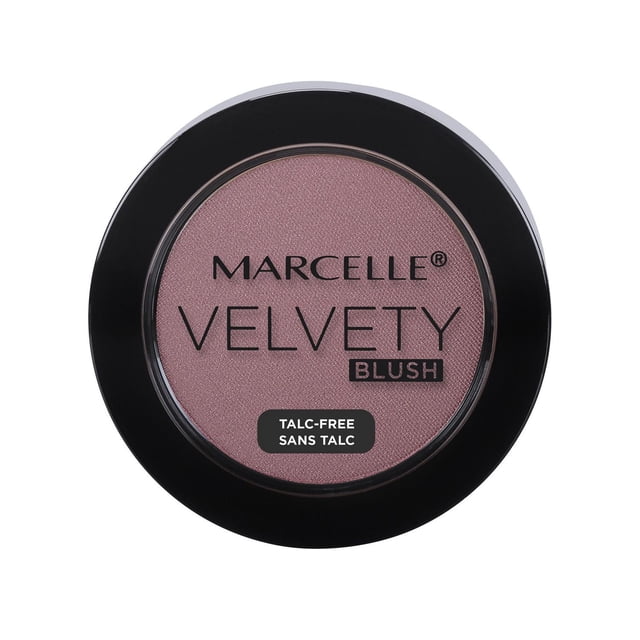 Marcelle Velvety Blush powder in a round black compact with clear lid, showing a soft mauve shade. This talc-free blush features a smooth, velvety texture and natural finish, enriched with vitamin E for antioxidant benefits, ideal for enhancing cheek radiance.