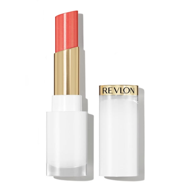 Super Lustrous™ Glass Shine Balm lipstick in sheer coral shade with white and gold tube, cap beside the open balm showing the Revlon logo on the gold band, formulated with hyaluronic acid and aloe for moisturizing, high-shine lip color.