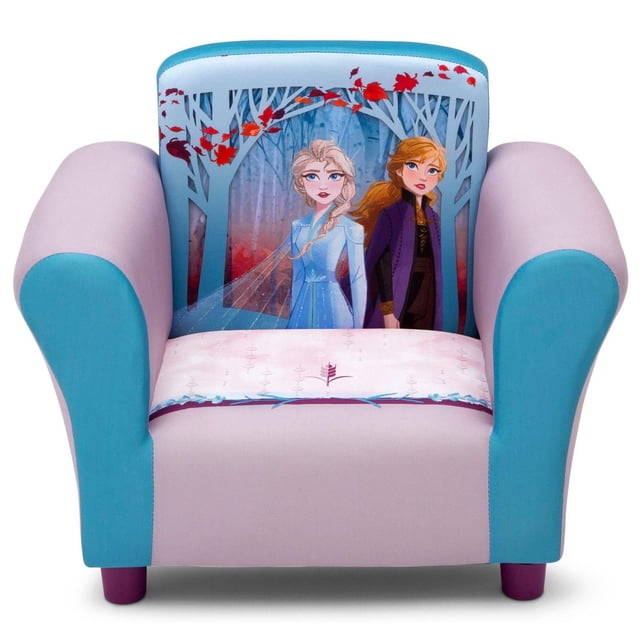 Disney Frozen II Kids Upholstered Chair by Delta Children with a front-facing view of a small armchair upholstered in light purple fabric and bright blue armrests. The padded backrest features detailed graphics of Frozen II characters Anna and Elsa in a forest with red leaves. The seat cushion is light pink with subtle patterns. The chair has a hardwood frame, purple legs, and storage pockets on both sides, suitable for children aged 3 and up and holding up to 100 lbs.