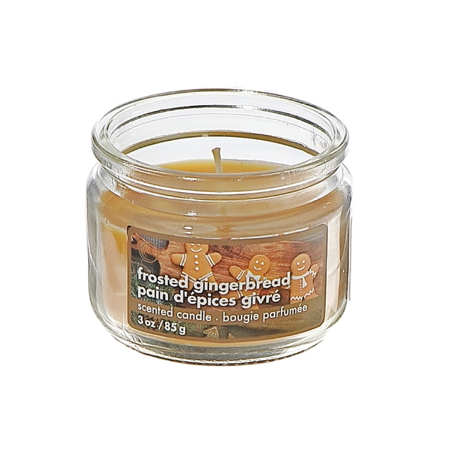 3 Oz Scented Jar Candle (Frosted Gingerbread) in a clear glass jar with light brown wax and a festive label featuring gingerbread men, ideal for holiday décor, gifting, and adding a warm seasonal scent to small spaces or gift baskets.