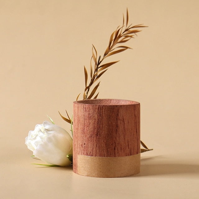EGNMCR Aromatherapy Diffuser, a 1.57-inch cylindrical wood oil diffuser, designed to improve sleep and enhance relaxation. The diffuser features a natural wood finish with a smooth texture and a notch at the top for essential oil application. Ideal for yoga, workouts, and contemplation, it is shown in a minimalist setting with a white flower and a decorative branch in the background.