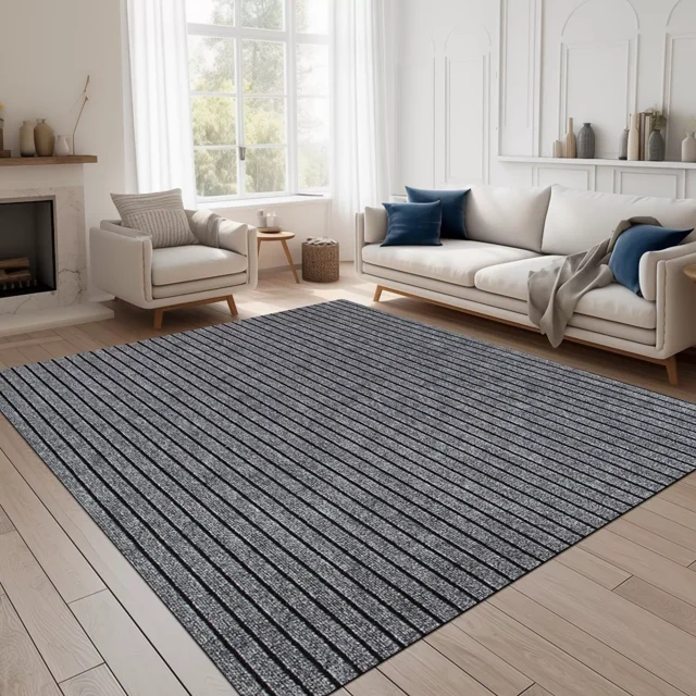 ANTPOP Runner Rug Non-slip Accent Rugs Washable Hallway Durable Polypropylene Indoor Outdoor with Rubber Backing for Entryways Kitchens Bedrooms, 2' x 8', Striped Gray. This runner rug features a striped gray pattern and a low-profile pile of 0.35 inches, suitable for high-traffic areas and placement under furniture. Made from fade-resistant and stain-resistant polypropylene, it includes a rubber backing for a secure, non-slip grip. Displayed in a contemporary living room with light wood flooring and neutral-toned furniture, the rug enhances the space while protecting floors from wear and tear.