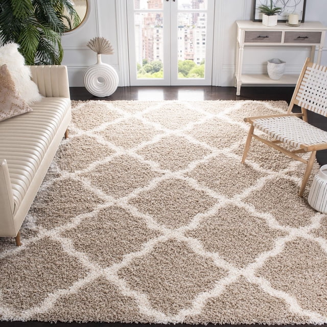 Safavieh Dallas Logan Geometric Shag Area Rug in beige with an ivory Moroccan tile pattern, featuring a 2-inch plush polypropylene pile and power-loomed durability. Displayed in a bright living room with a cream leather sofa and woven chair, this rug adds a modern accent and soft comfort, often used to enhance cozy seating areas.