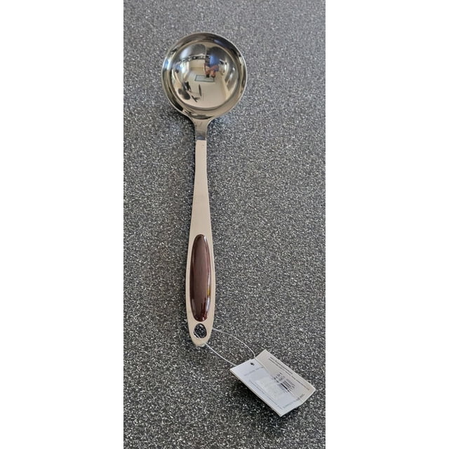SUNWEALTH Heavy-Duty Stainless-Steel Soup Ladle with a round bowl and long handle featuring a dark brown grip insert and hanging hook, resting on a grey textured countertop with a product tag attached, suitable for serving soup and kitchen use.