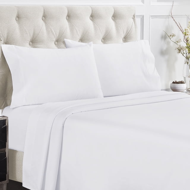 California Design Den Sheet Sets, Natural 100% Cotton Sheets with a 400 thread count sateen weave, displayed on a neatly made bed. The set includes a flat sheet, a fitted sheet with deep 41 cm pockets, and two pillowcases, all in a crisp white color. The bedding is shown in a bright, elegant bedroom setting with a tufted beige headboard and decorative accents.