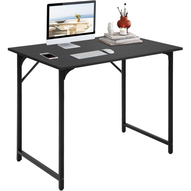 BestOffice 32 Inch Computer Desk in black with a modern minimalist design, featuring a sturdy metal frame, adjustable leg pads, and a smooth wood surface. The desk is shown with a computer monitor, keyboard, mouse, and decorative items, highlighting its spacious desktop suitable for home office, study, writing, or light gaming tasks.