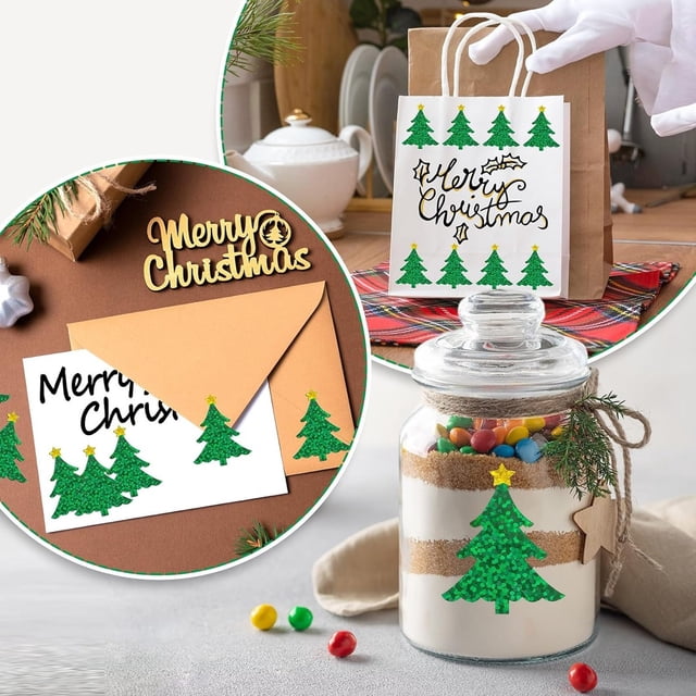 Christmas Decorations OutdoorStickers500Pcs Christmas Tree Stickers Roll featuring green tree-shaped adhesive decals. The stickers are displayed on various surfaces, including a gift bag, an envelope, and a glass jar, showcasing their versatility for holiday decorations. Each sticker measures approximately 1.5 inches and is made of durable PET material with a self-adhesive backing. Ideal for envelopes, journals, scrapbooks, and festive crafts.