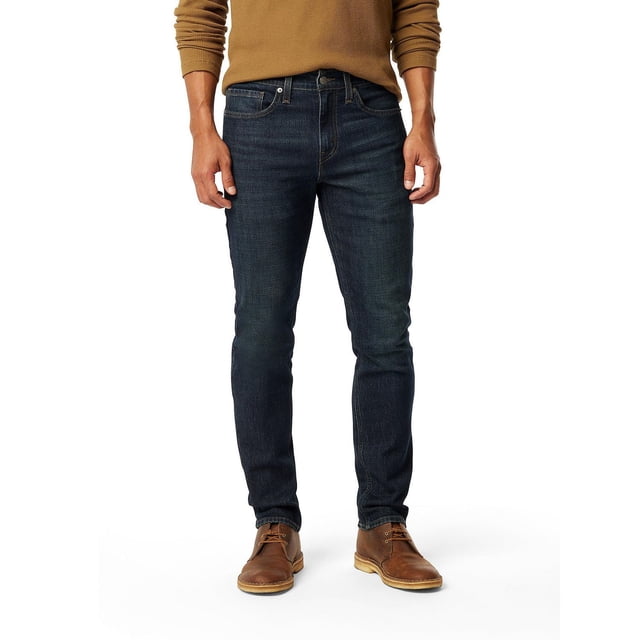 Levi Strauss Signature™ Men's Slim Fit Jeans in dark blue Ultimate Flex Denim with slim fit through seat, thigh, and leg opening, zip fly, and five-pocket styling, worn with brown boots and sweater, ideal for casual and smart-casual occasions.
