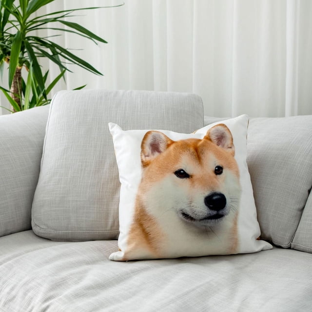 Gouchee Home Shiba Inu Cushion 18" x 18" on a light grey textured sofa. The square throw pillow features a digital print of a Shiba Inu dog on white polyester canvas with ears visible at the top and a solid yellow-gold velvet reverse. Positioned near a green plant and white curtains, this decorative pillow adds a playful accent to home décor and is suitable for living room use.