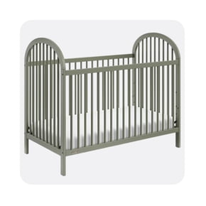 A gray baby crib with vertical slats and arched headboards on both ends, shown with a white mattress inside.