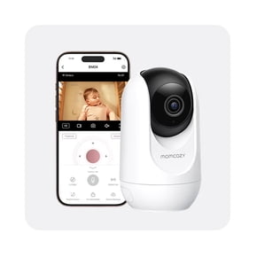 White smart baby monitor camera beside a smartphone displaying a baby on the screen.