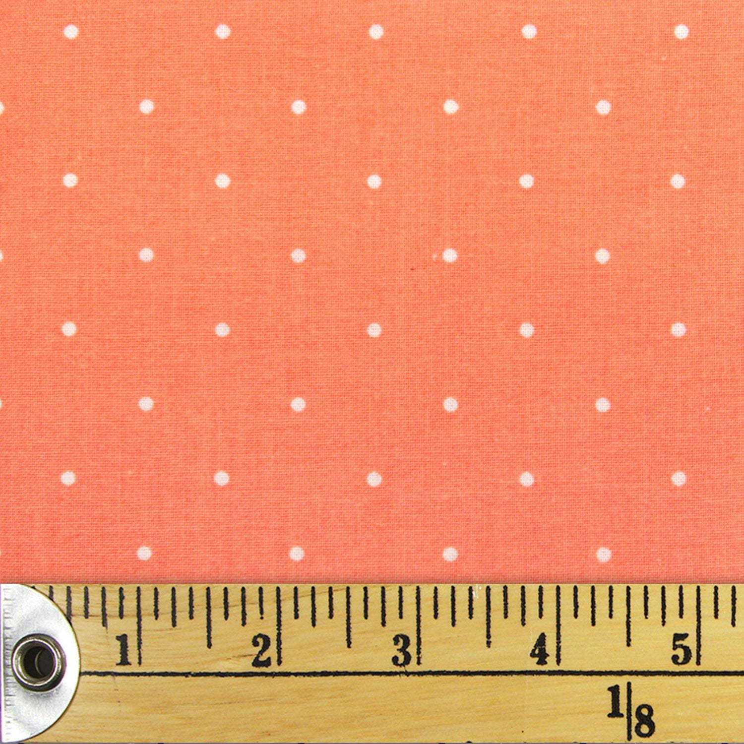 coral and white polka dot fabric