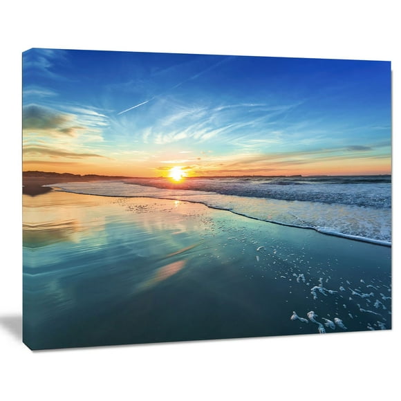 Design Art Blue Seashore with Distant Sunset Seashore Canvas Wall Art