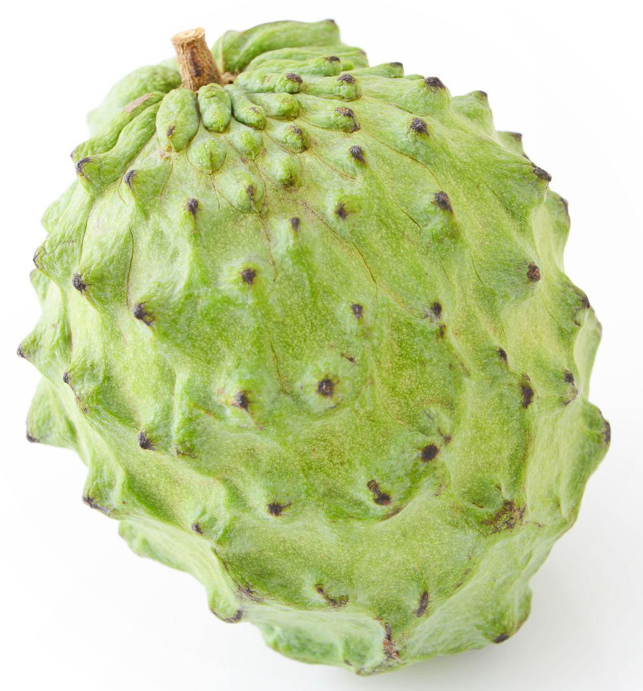Atemoya, By bulk centered close-up of several Atemoya fruits; heart-shaped, green-to-yellow bumpy skin and matte texture visible, arranged on a white surface under soft natural light; bulk fresh produce with freshness guaranteed in product details, often used whole or blended into smoothies.
